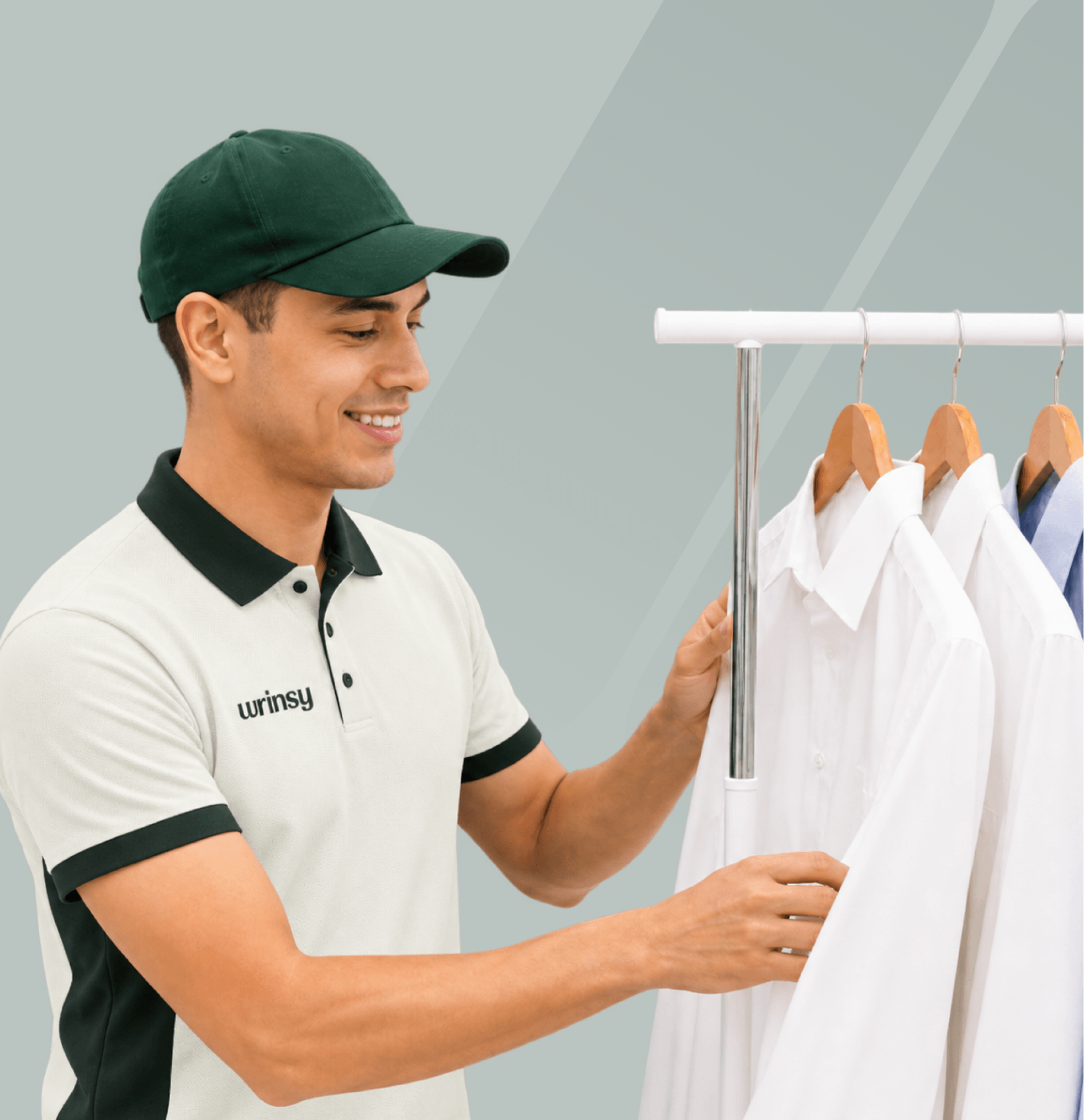 A wrinsy team member arranging freshly cleaned shirts on a rack