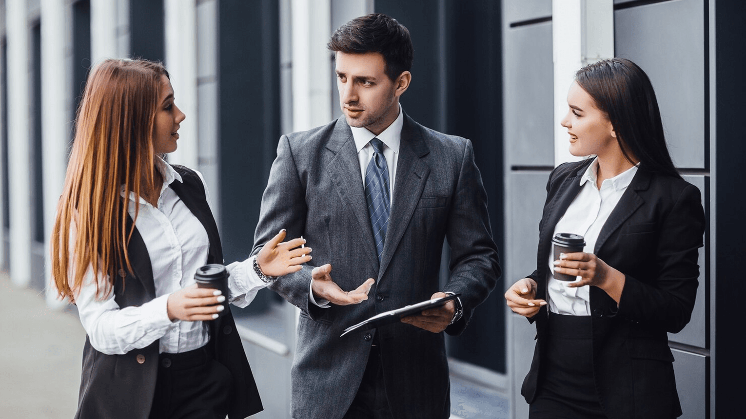 Two people reviewing property plans at a desk