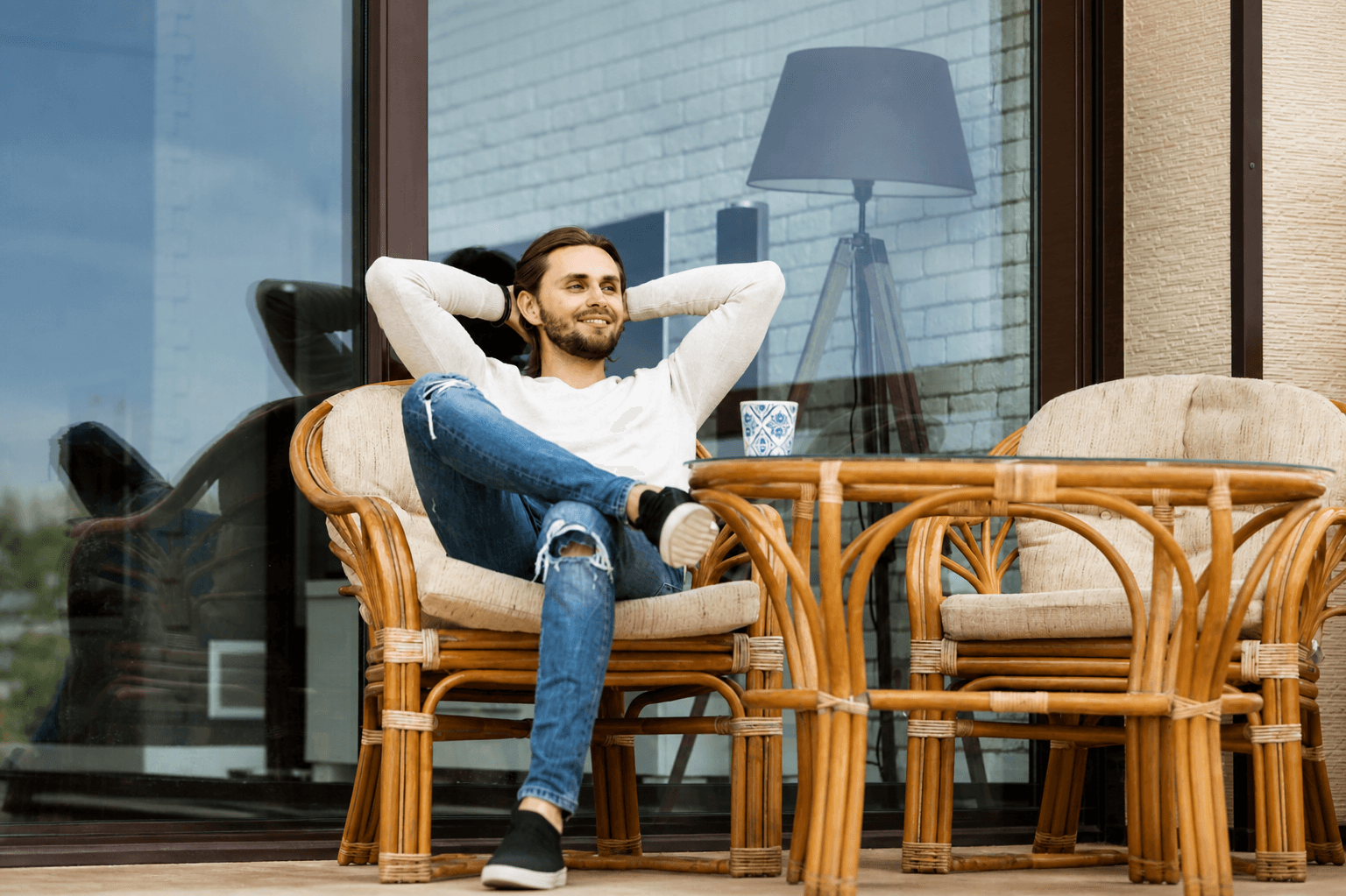 A resident relaxing on a balcony, free from the chore of laundry